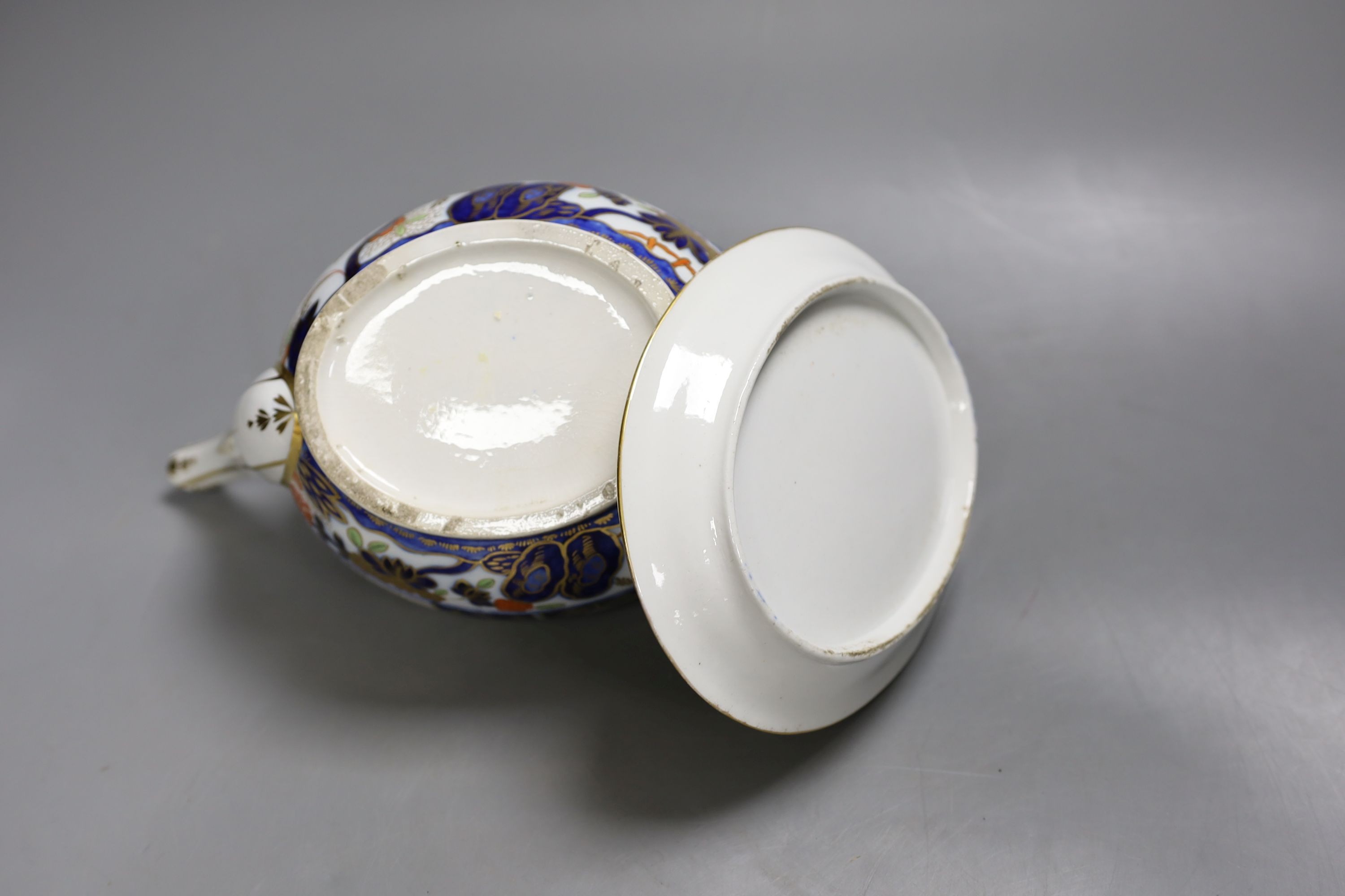 A Chamberlain teapot cover and stand painted with an Imari pattern, c.1810, 26cm long
